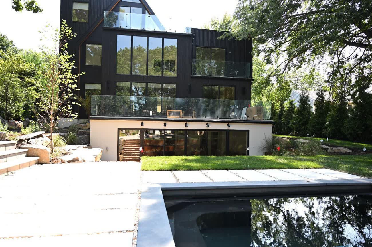 Frameless glass railing installed on a modern New Jersey home rooftop deck