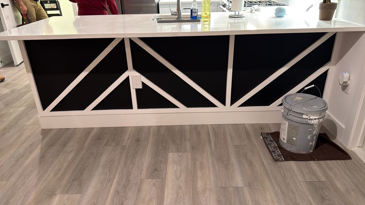 Black and white geometric wood trim accent on a kitchen island